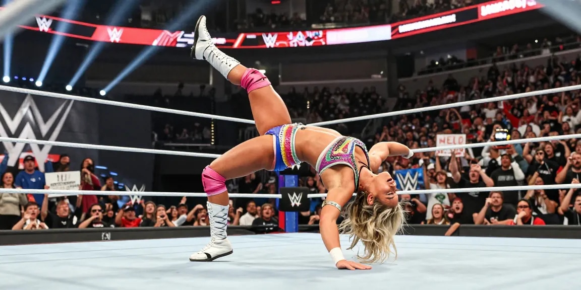 Alexa Bliss executing her signature move in the WWE ring, showcasing vibrant wrestling attire and an electrifying atmosphere.